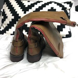 Tall brown boots with red zipper accent